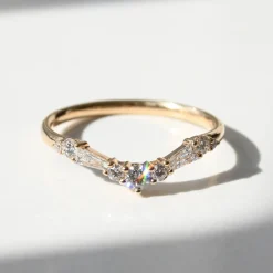 Tomfoolery Tapered Baguette and Round Diamond Arched Band Fashion